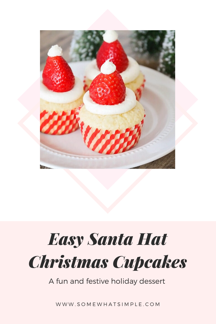 Santa hat cupcakes are a fun and festive dessert to serve during the Christmas holidays.  Topped with a fresh strawberry and homemade frosting, you won't be able to just eat one of these cupcakes. These are the perfect festive dessert idea to serve at your next Christmas party. via @somewhatsimple