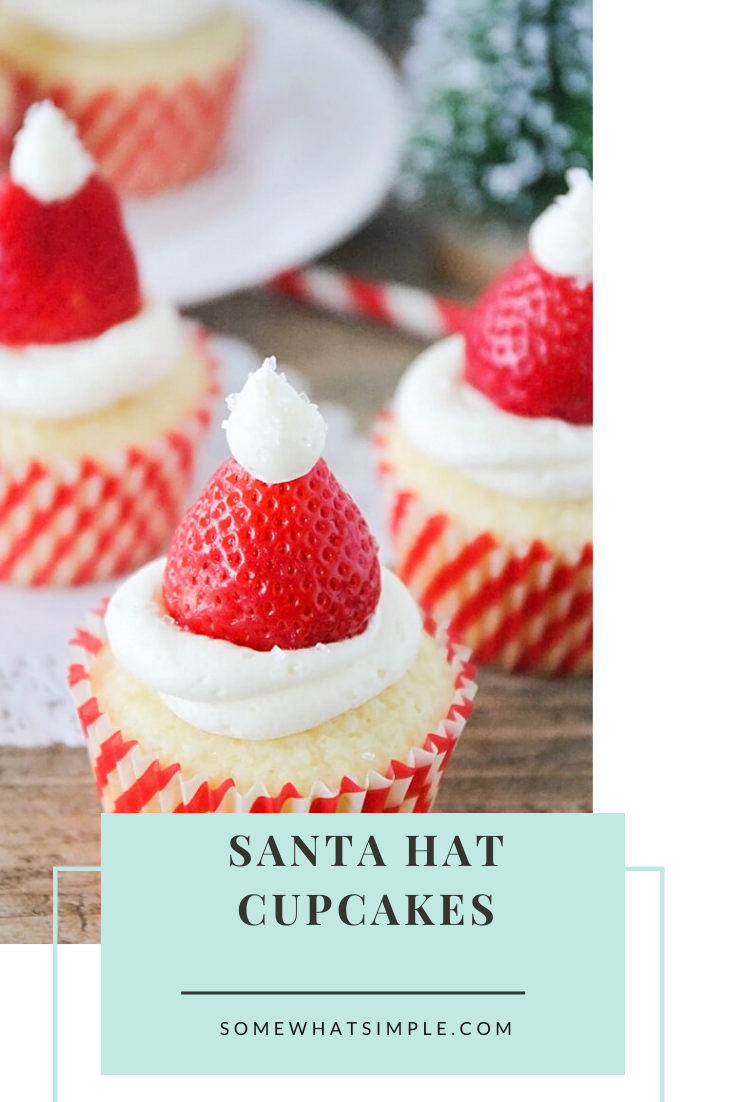 Santa hat cupcakes are a fun and festive dessert to serve during the Christmas holidays.  Topped with a fresh strawberry and homemade frosting, you won't be able to just eat one of these cupcakes. These are the perfect festive dessert idea to serve at your next Christmas party. via @somewhatsimple