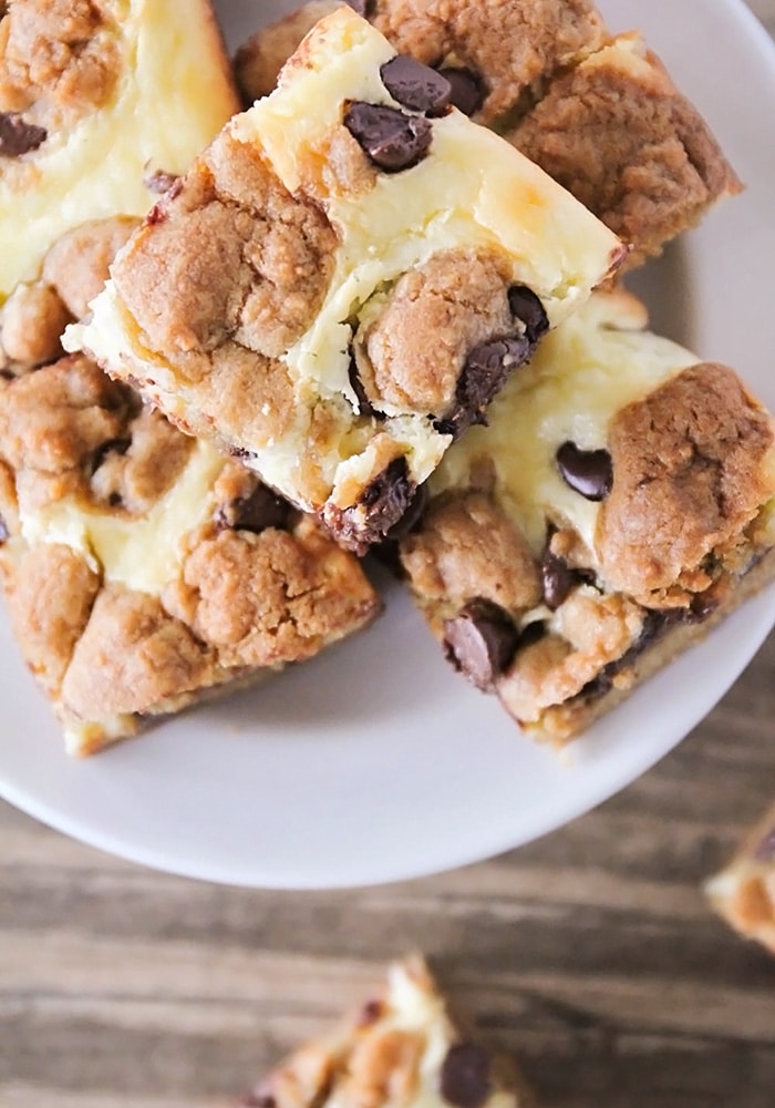 looking down on a white play full of chocolate chip cheesecake cookie bars made with this easy recipe