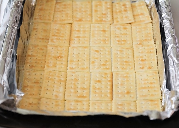 a baking sheet lined with club crackers