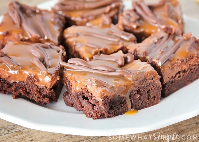 a plate of Milky Way Brownies topped with caramel & chocolate