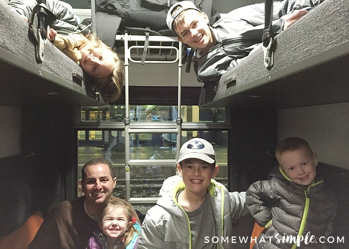 a handsome man with his five children inside a Thello sleeper car getting ready for their trip on the European night train from Paris to Venice