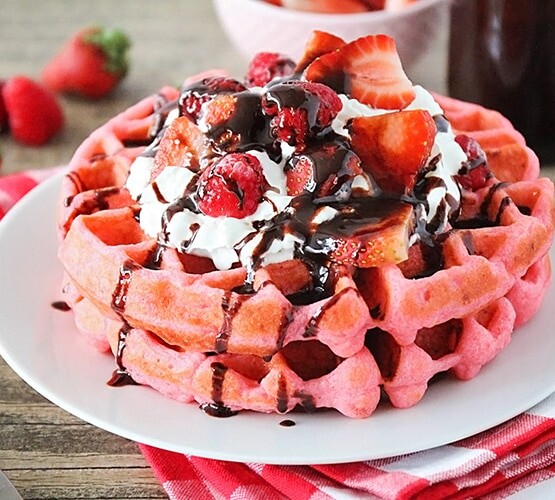 plated pink velvet waffles on a white plate