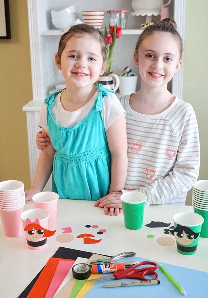 two girls making powerpuff girls snack cups