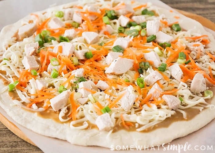 an uncooked Thai Chicken PIzza