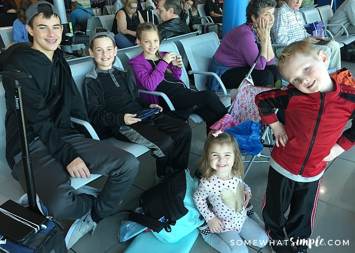 five children sitting in the Rome airport waiting for their flight at the end of their European family vacation