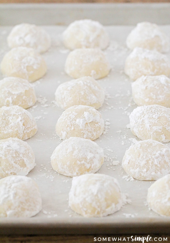Balls of dough spread out on a cookie sheet ready to be placed in the oven