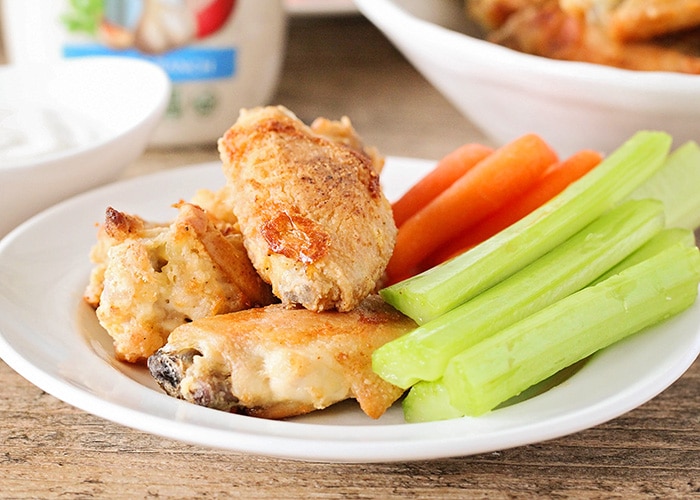 Baked Chicken Wings on a plate with carrot and celery sticks
