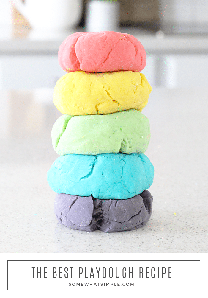different colors of homemade playdough in a stack on a counter