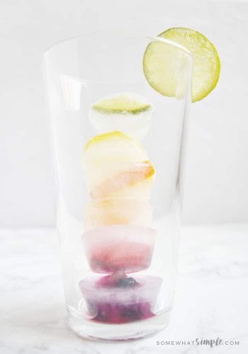 tall glass with fruity ice cubes stacked inside
