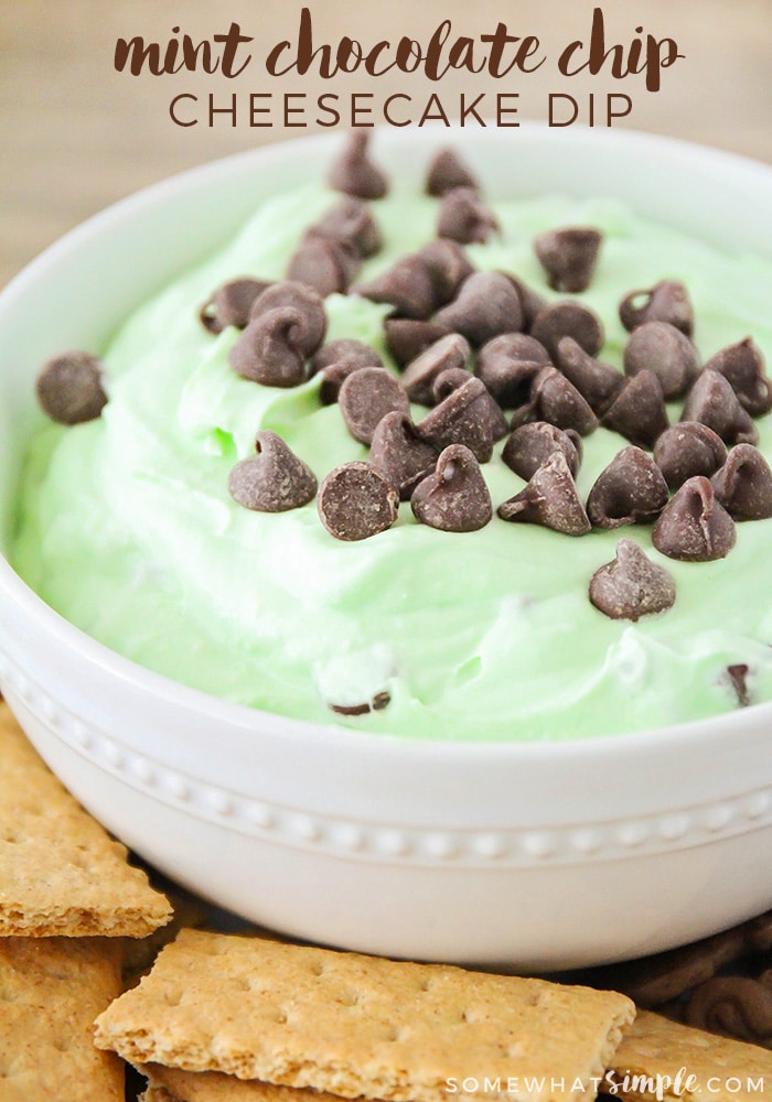 close up of a bowl of green mint cheesecake dip topped with chocolate chips