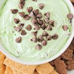 looking down on a bowl of green mint Cheesecake Dip topped with chocolate chips