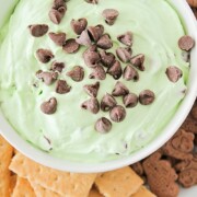 looking down on a bowl of green mint Cheesecake Dip topped with chocolate chips