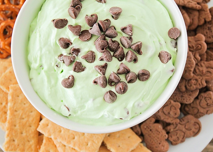 looking down on a bowl of green mint Cheesecake Dip topped with chocolate chips