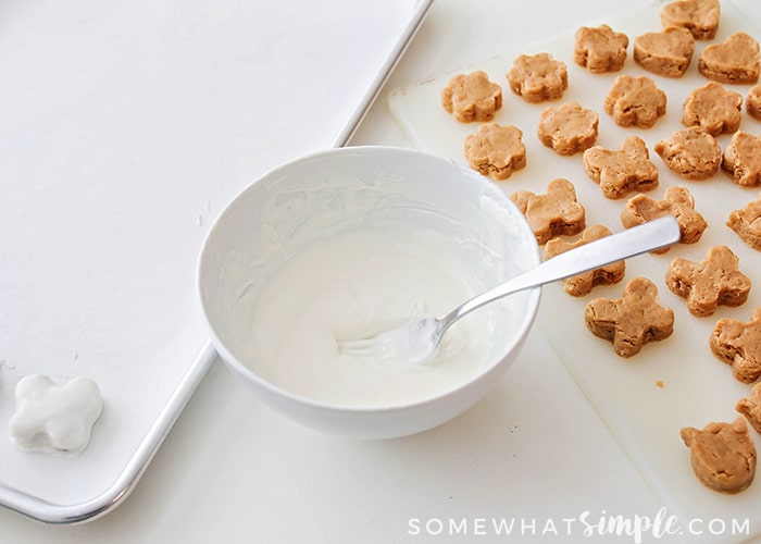 white melting chocoalte in a bowl next to peanut butter truffles