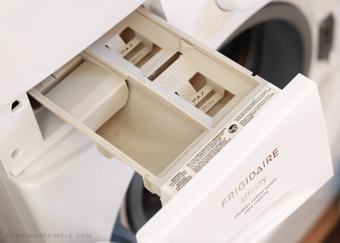 looking down into a clean laundry detergent tray that was clean using hot water and all purpose cleaner