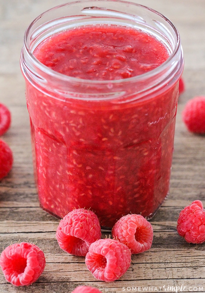a jar of homemade raspberry sauce that is the key ingredient to this simple raspberry lemonade recipe