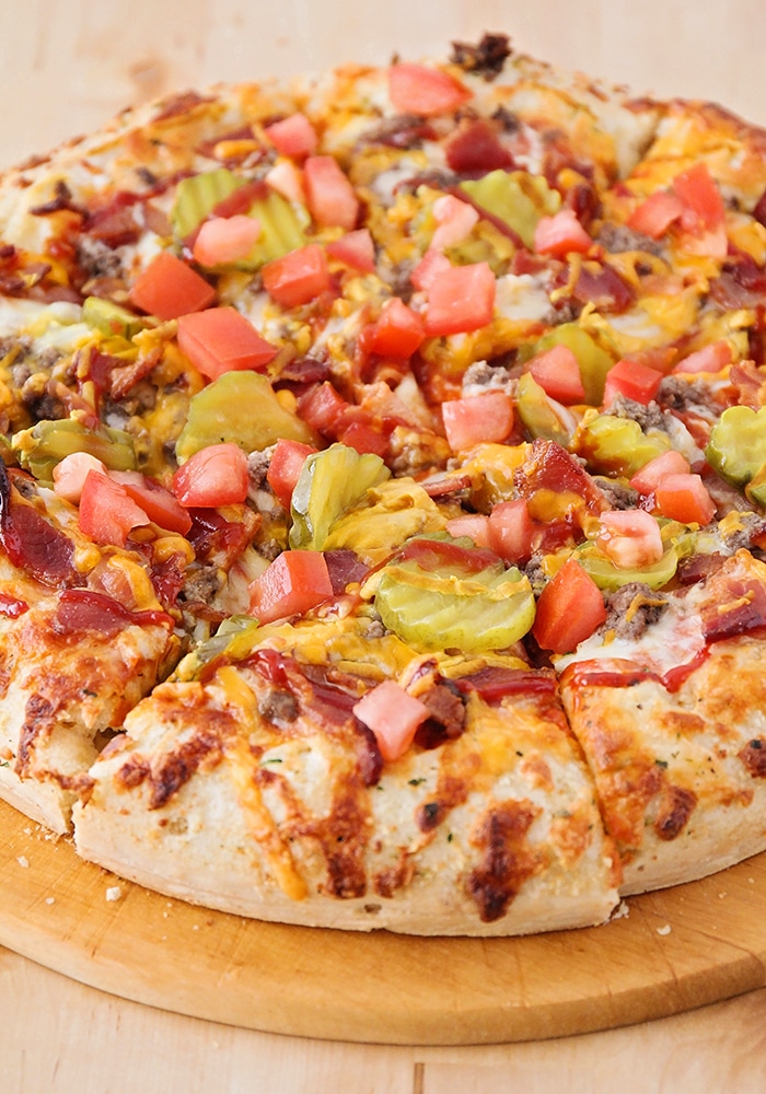 a close up of a fully cooked bacon cheeseburger pizza