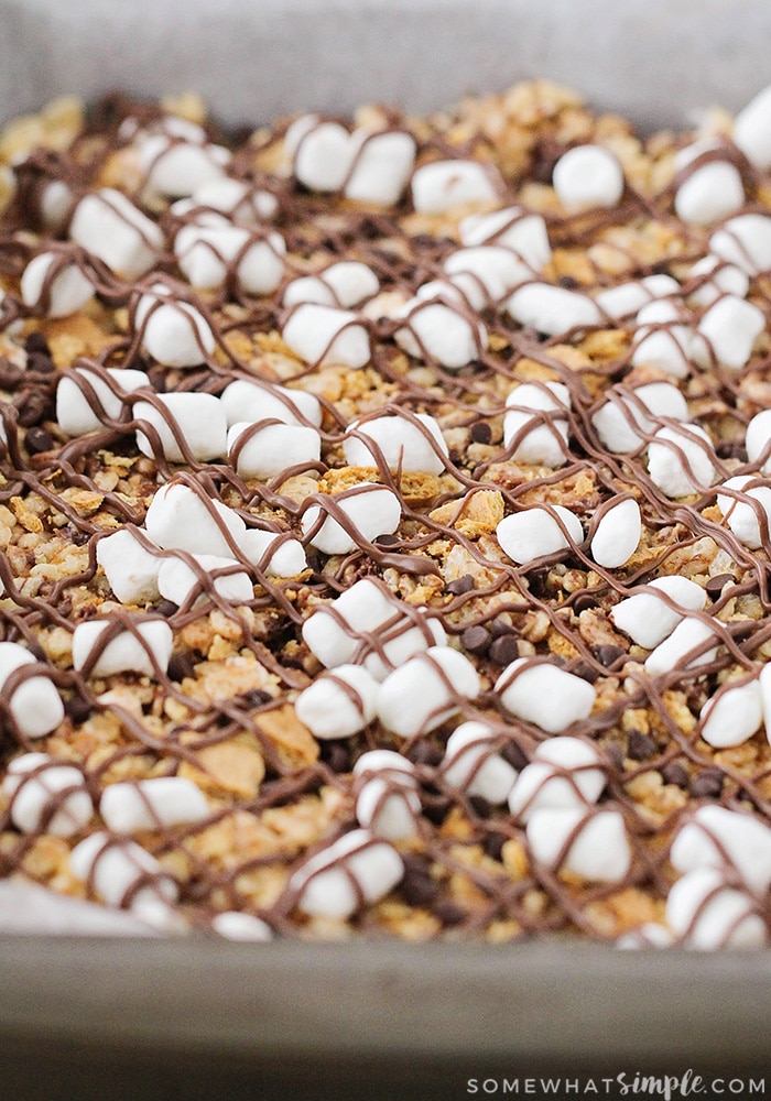 a tray of rice krispie treats topped with marshmallows and graham crackers