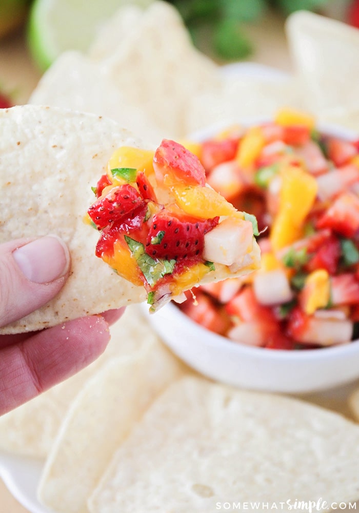 a tortilla chip with a salsa made with fresh fruit