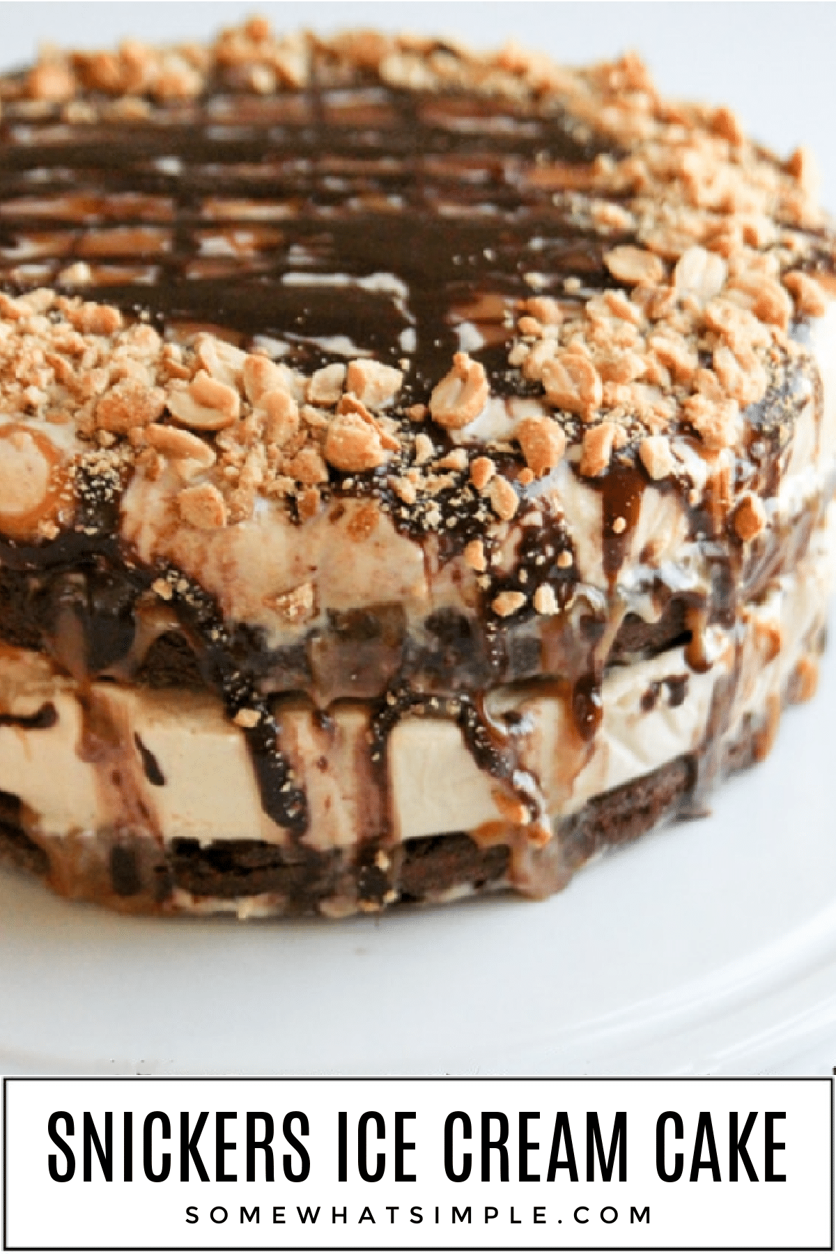 Homemade snickers ice cream cake is layered with peanut butter ice cream, fudgy brownie, salted caramel, fudge, and chopped peanuts. via @somewhatsimple
