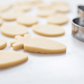 raw sugar cookie dough next to a metal cookie cutter