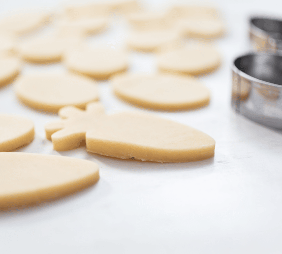 raw sugar cookie dough next to a metal cookie cutter