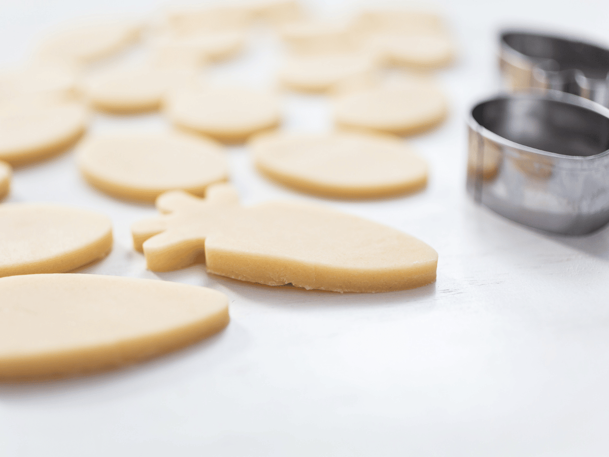 raw sugar cookie dough next to a metal cookie cutter