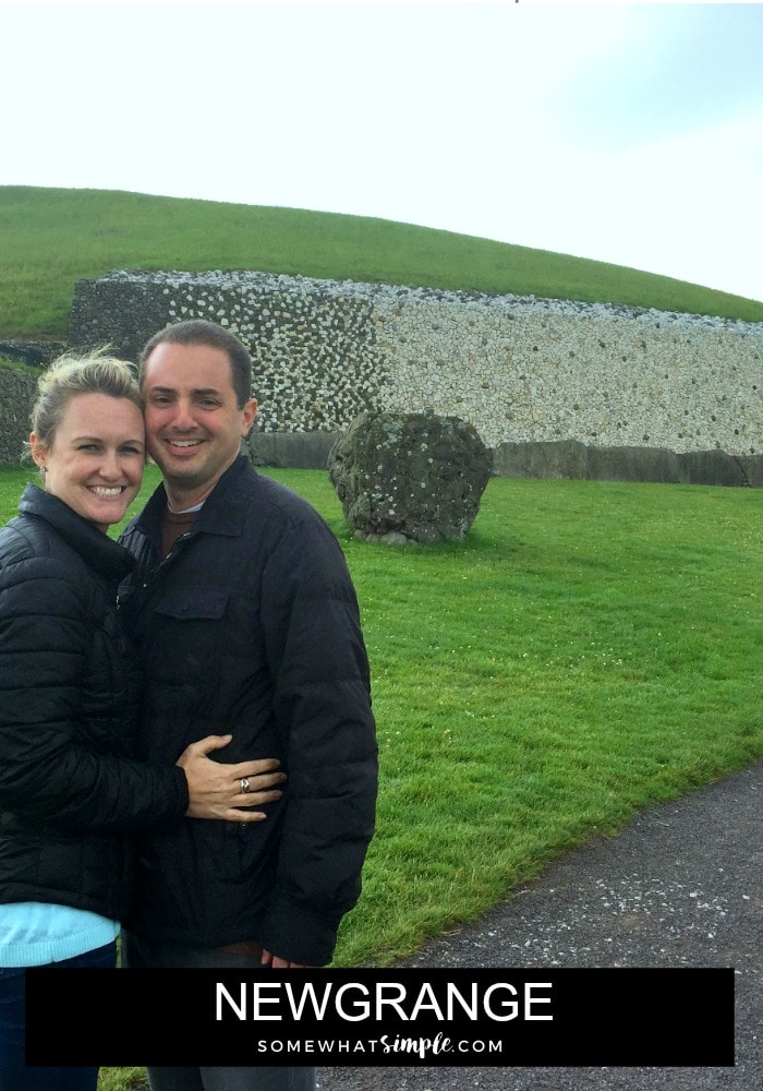 an attractive couple standing outside of Newgrange in Ireland