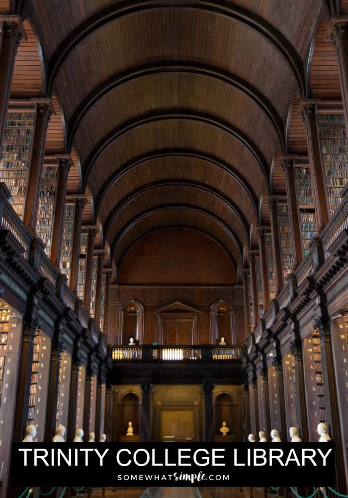 looking down the main hallway inside the Trinity College Library in Dublin with stacks of books on both sides 