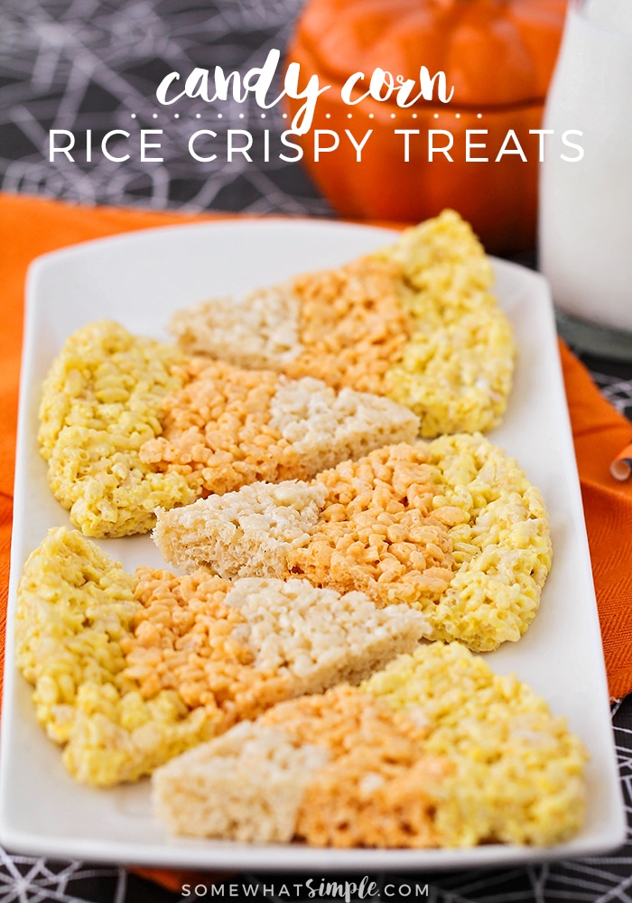 These candy corn rice krispy treats are a fun seasonal twist on a traditional treat! You can enjoy an enjoy a classic dessert recipe in the shape of everyone's favorite fall candy. These rice krispies treats are super easy, delicious and perfect for fall! via @somewhatsimple