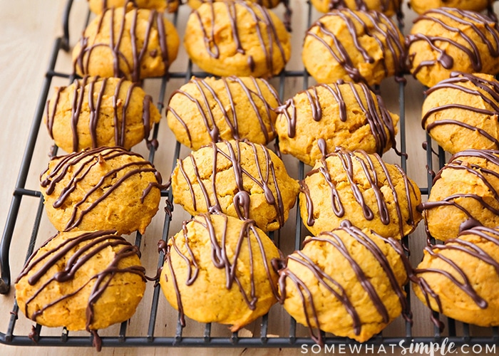 a cooling rack filled with cookies topped with a chocolate glaze
