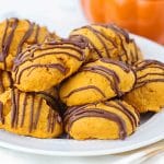 a plate full of chocolate glazed pumpkin cookies