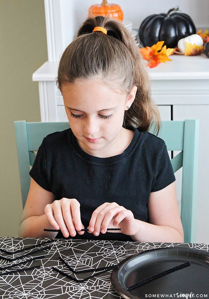 a girls making a paper plate craft