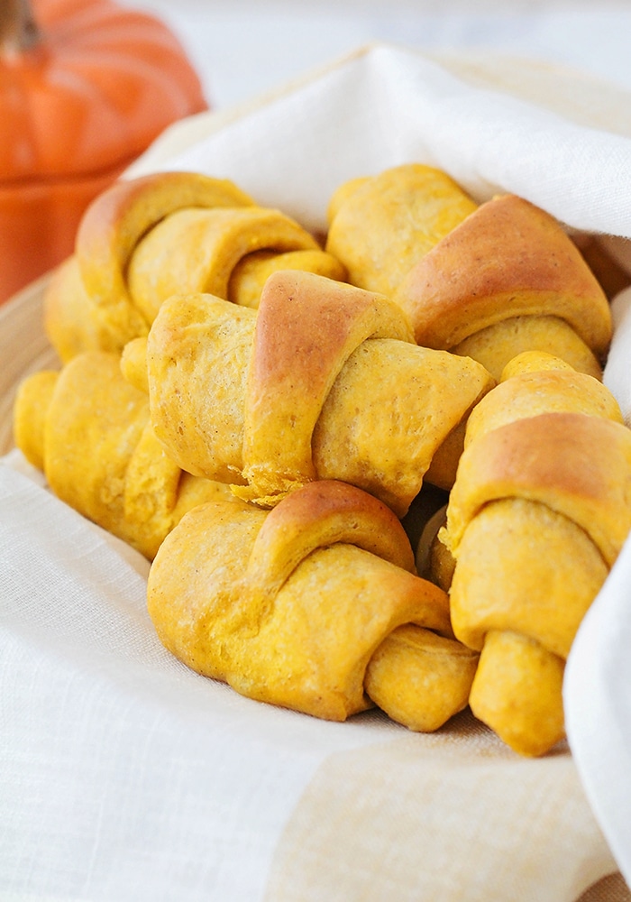 a basket of pumpkin dinner rolls