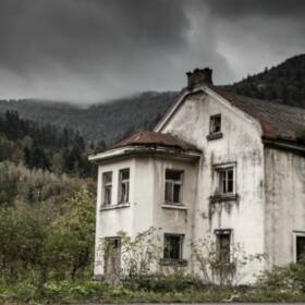 Old white hotel in a haunted field