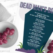 dead mans body poem printed on white paper with a bowl of grapes by its side
