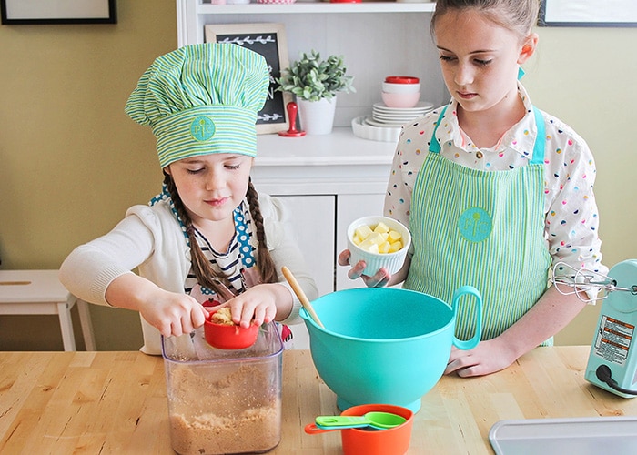 two young girls making cookies