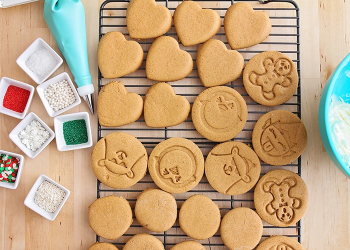 looking down on a rack of baked cookies next to decorations