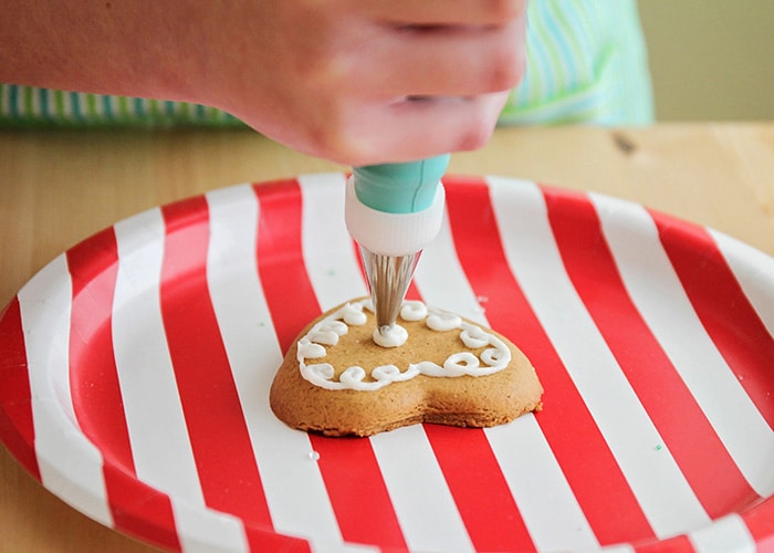 icing being piped onto a cookie