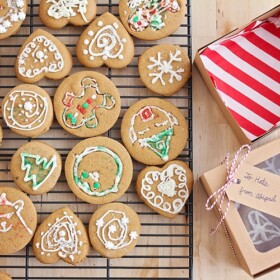 a cooling rack filled with decorated gingerbread cookies