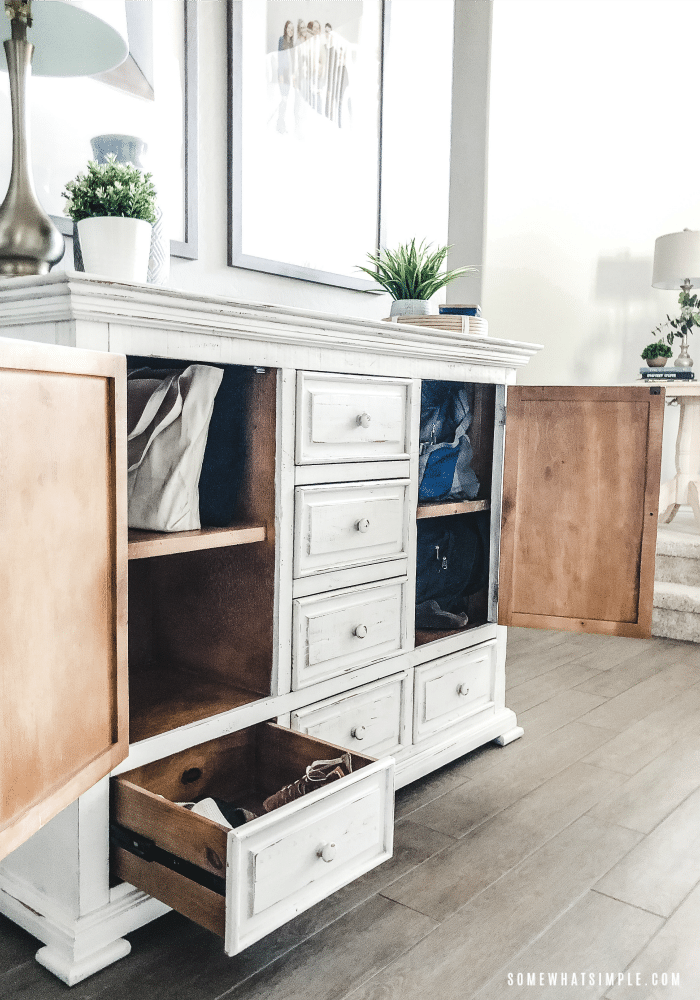 a white cabinet that is open displaying a lot of storage.