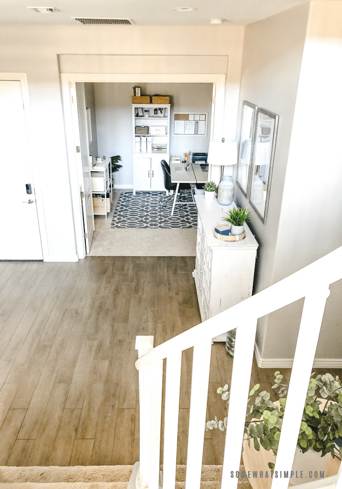 looking down from the stairs into the entry way of a home. 