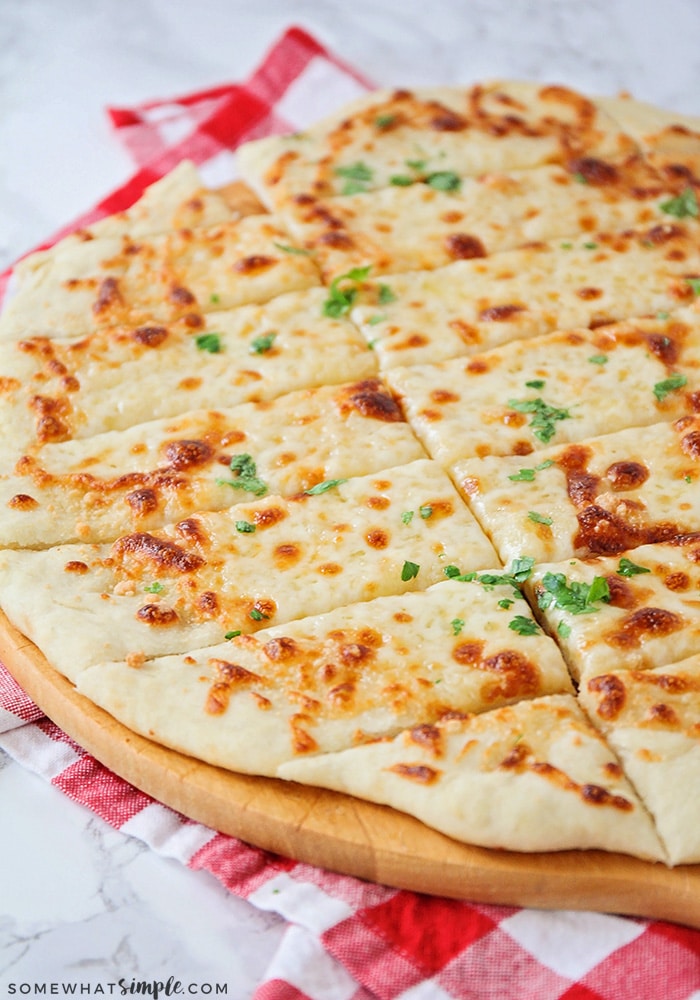 cheesy breadsticks on a baking stone