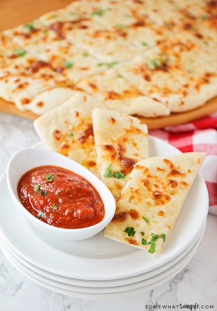 homemade cheesy breadsticks with a side of marinara sauce