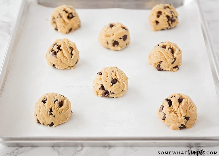 balls of Chocolate Chip Cookie dough on a baking sheet