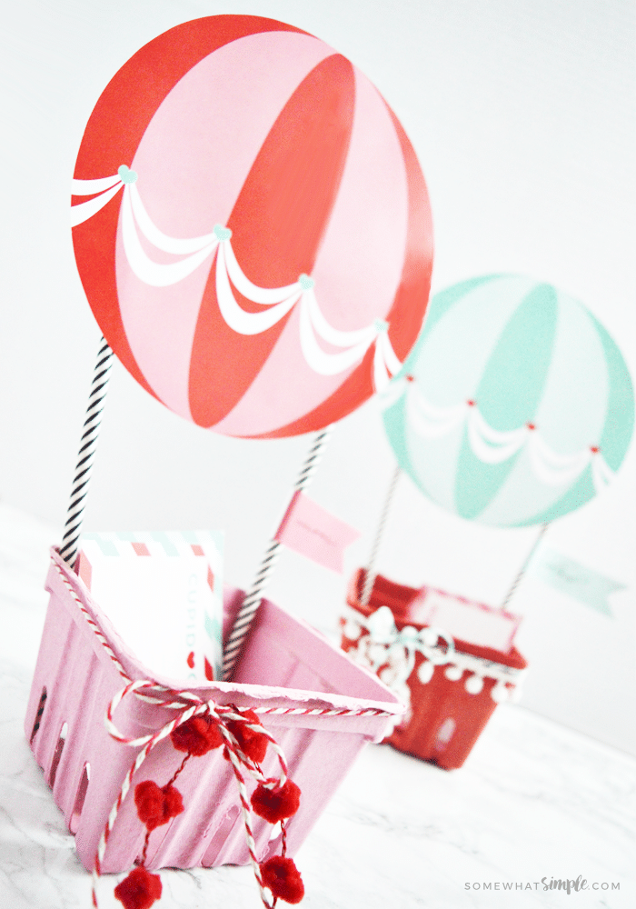 a red and a blue hot air balloon Valentine box made with these printables