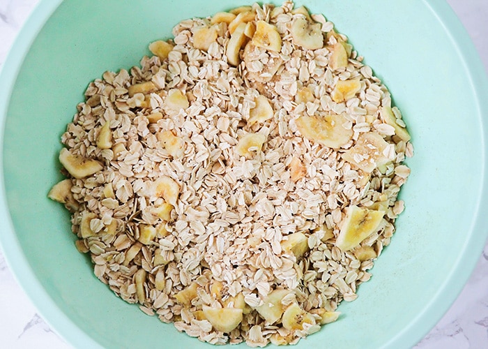 adding oatmeal to a large mixing bowl