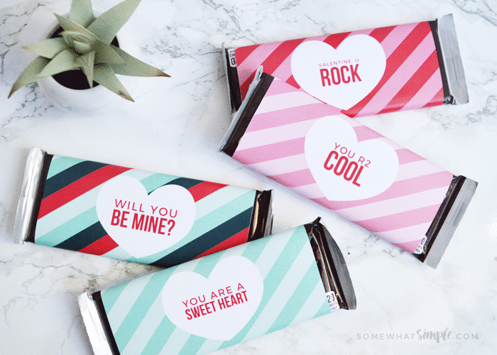 four Hershey candy bars on a counter wrapped in this valentine printable.