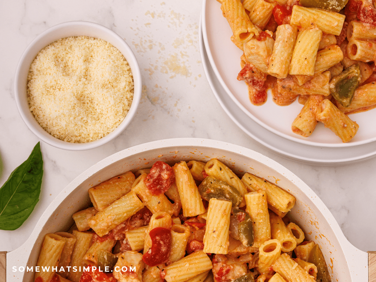 Chicken Riggies next to a small bowl of parmesan cheese